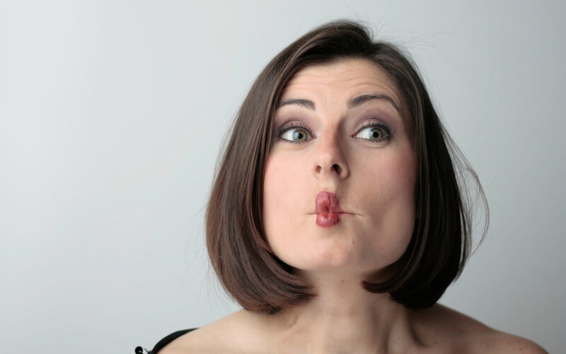 woman making a kissing face