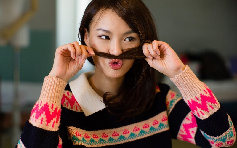 woman making a mustache with her hair