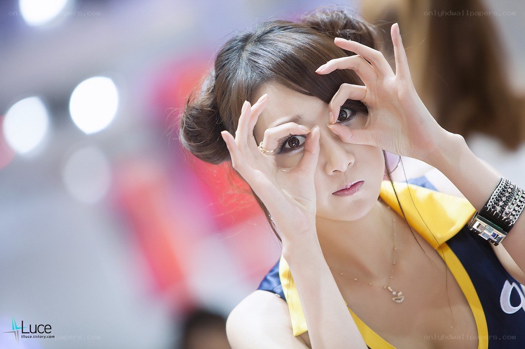 Woman making eye shape with hands