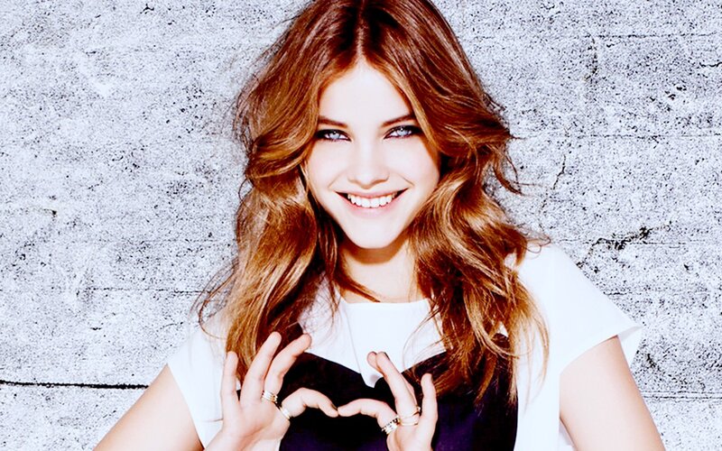 woman making heart shape with hands