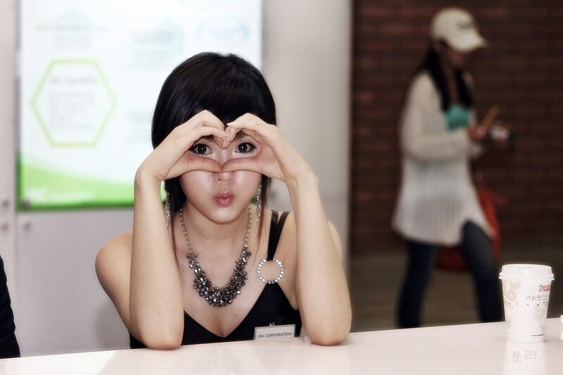 woman making heart shape with hands