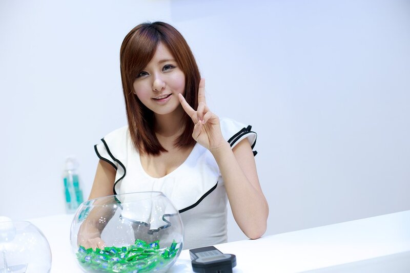 Woman making peace sign at desk