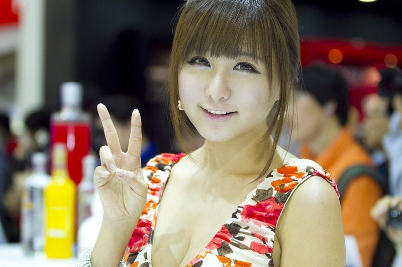Woman making peace sign at event