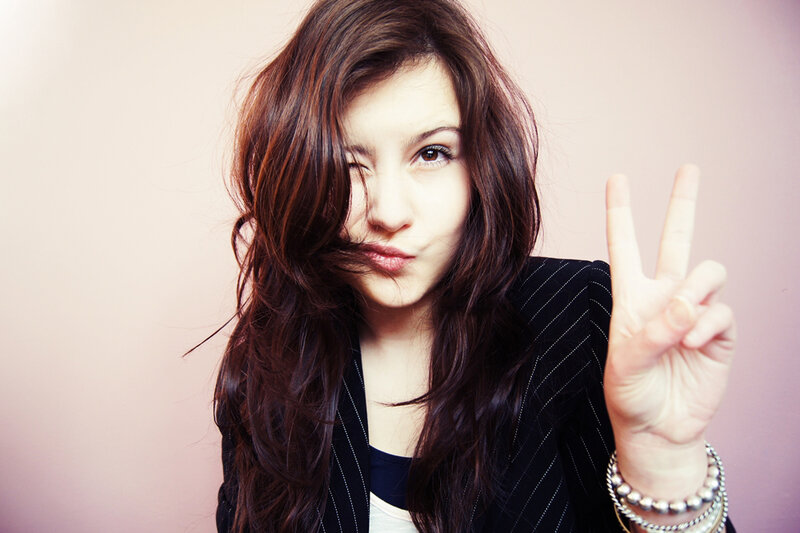 Woman Making Peace Sign — Brown