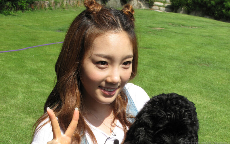 woman making peace sign with dog