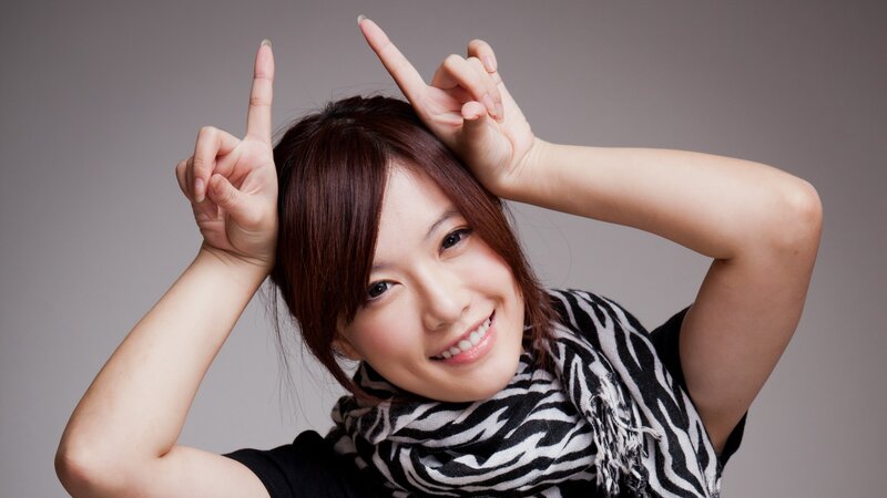woman making rock on hand gesture