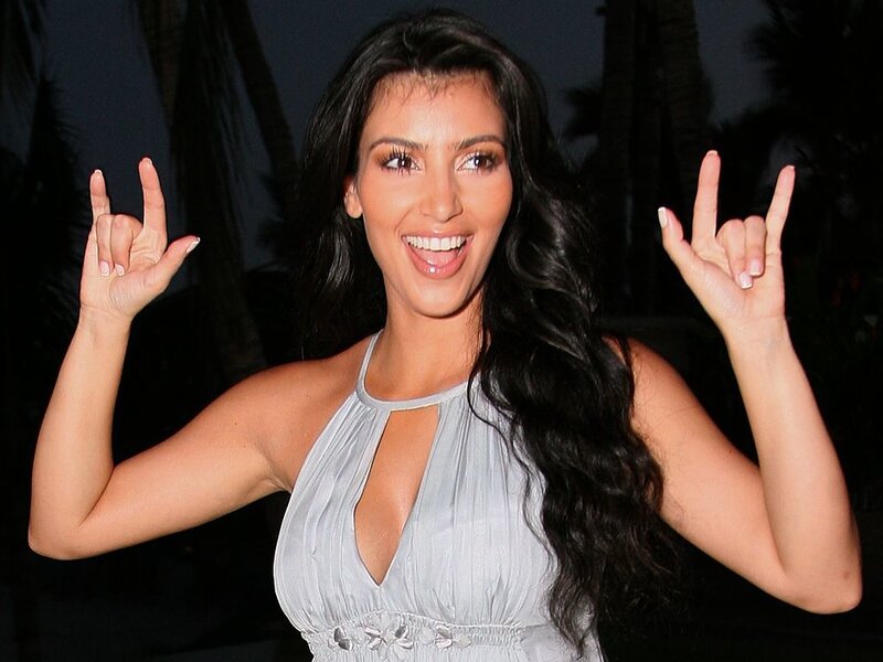 woman making rock on hand gesture