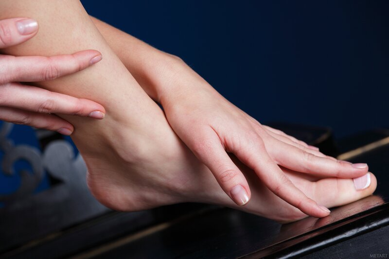 woman massaging her feet