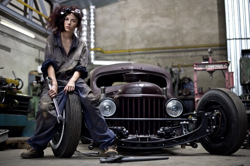 woman mechanic with vintage car