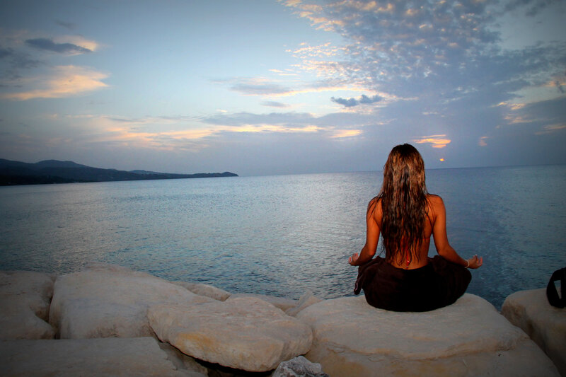 Woman meditating by the sea