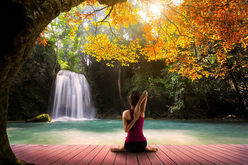 Woman Meditating by Waterfall — Orange