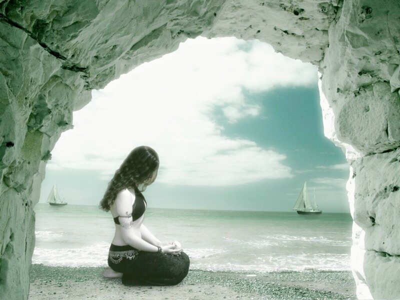 Woman meditating in a cave