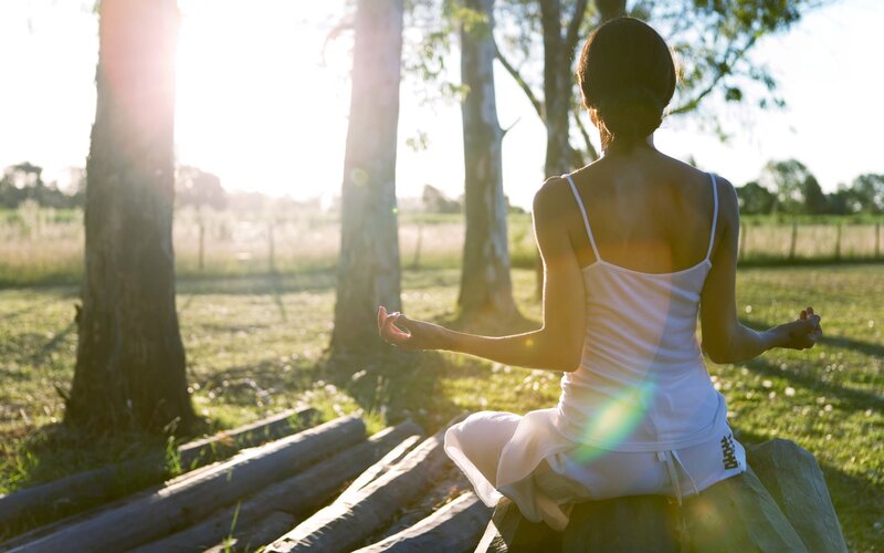 Woman meditating in a field