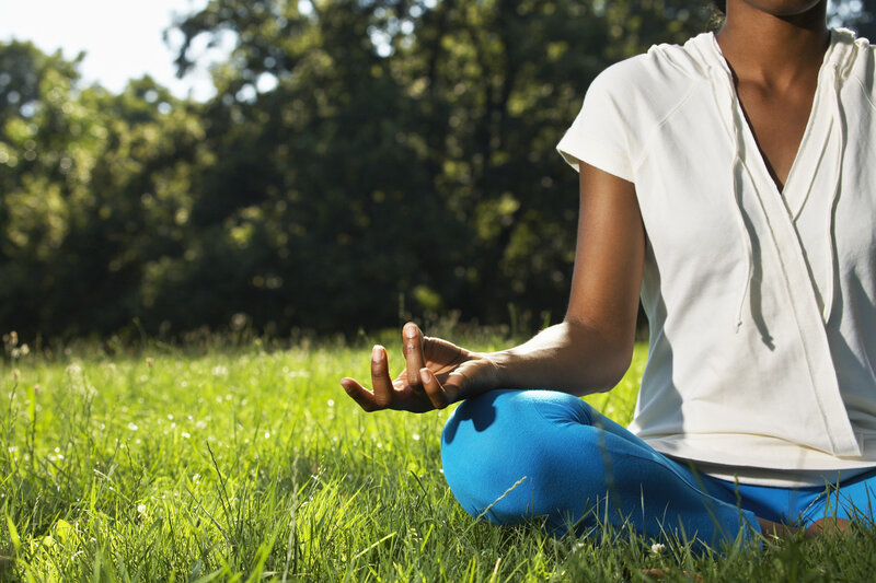 Woman meditating in a park