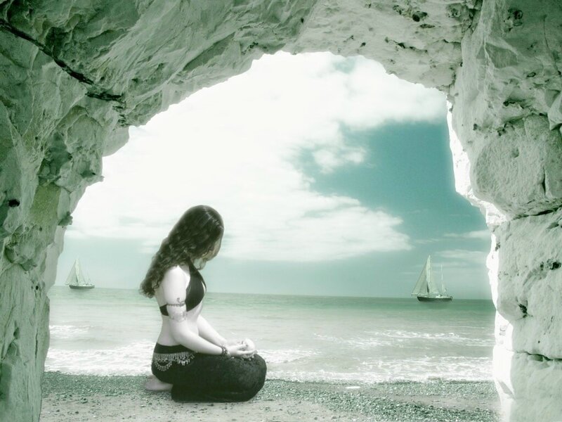 Woman Meditating in Cave