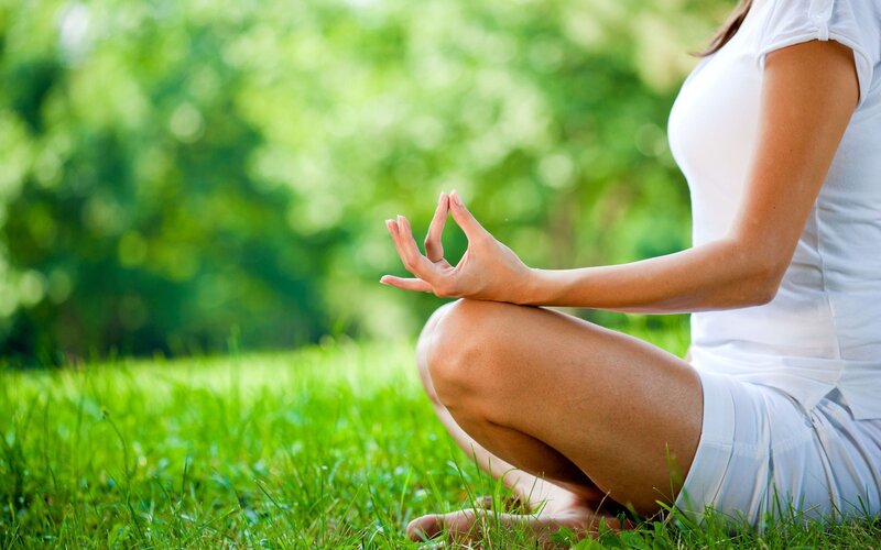 woman meditating in garden