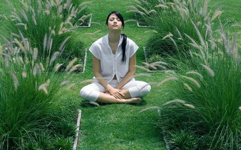 Woman Meditating in Grass