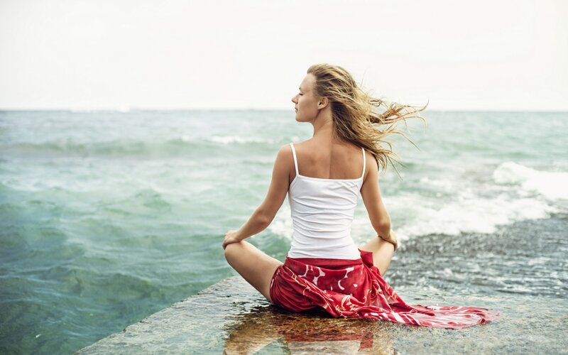 Woman Meditating on Rock — White
