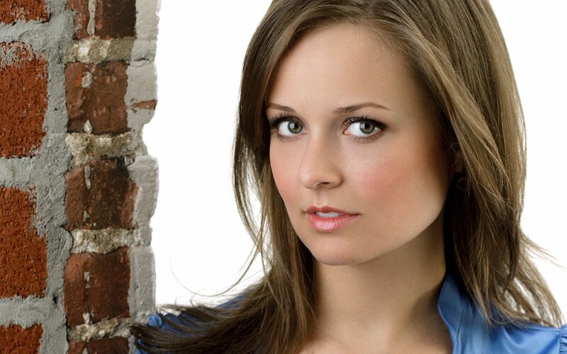 woman near brick wall