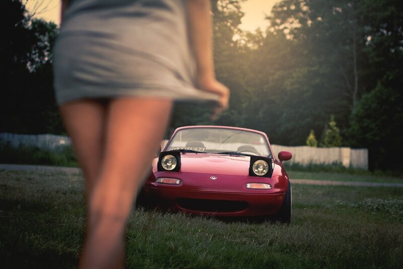 Woman near red sports car