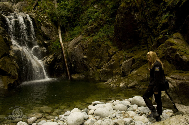 Woman near waterfall in forest