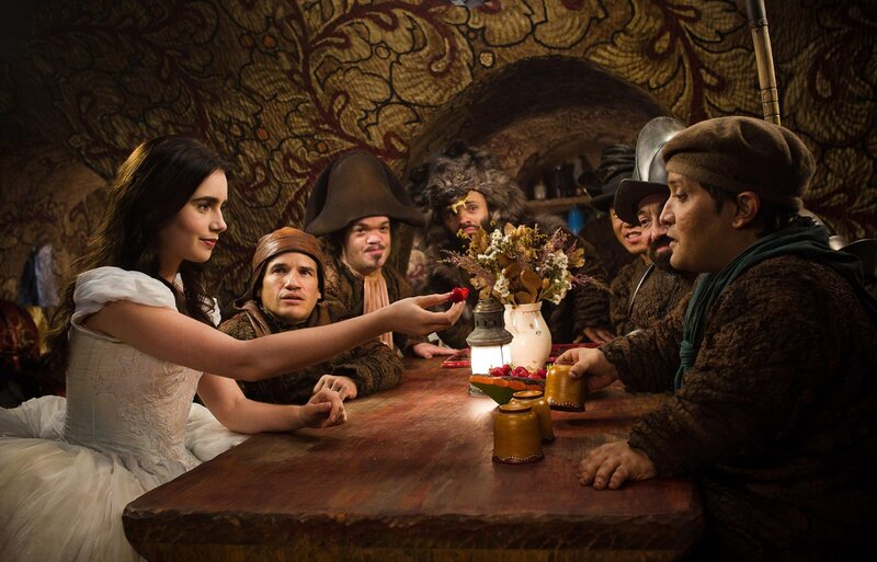 Woman Offering Berry to Men