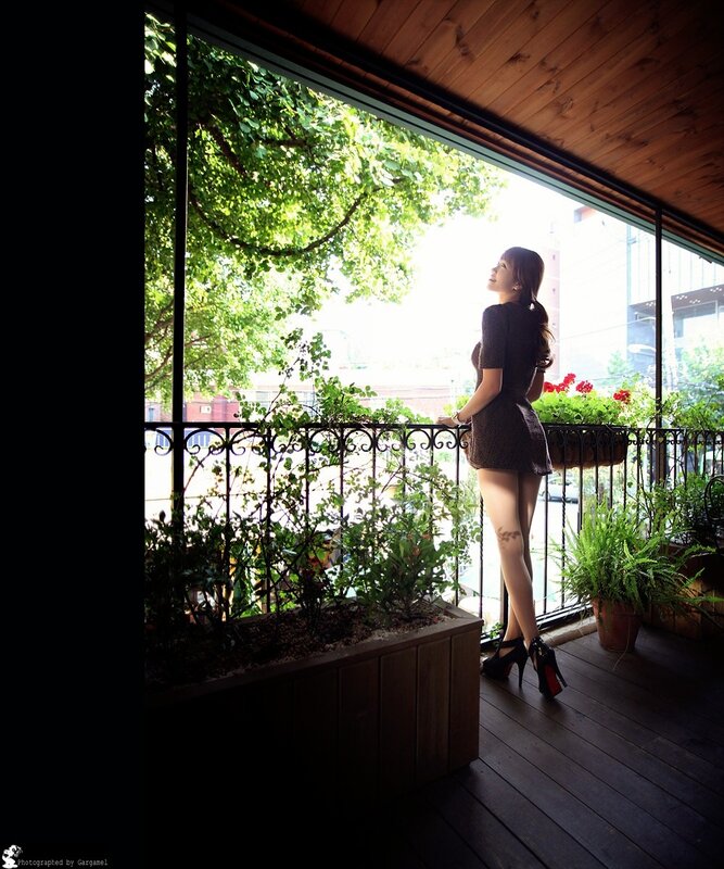 Woman on a balcony with plants