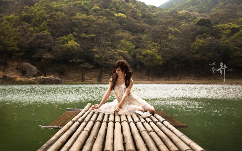 Woman on a bamboo raft