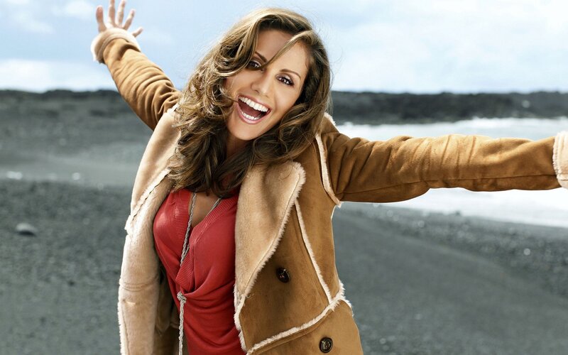 woman on a beach smiling