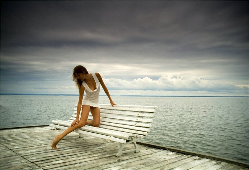 Woman on a bench by the water