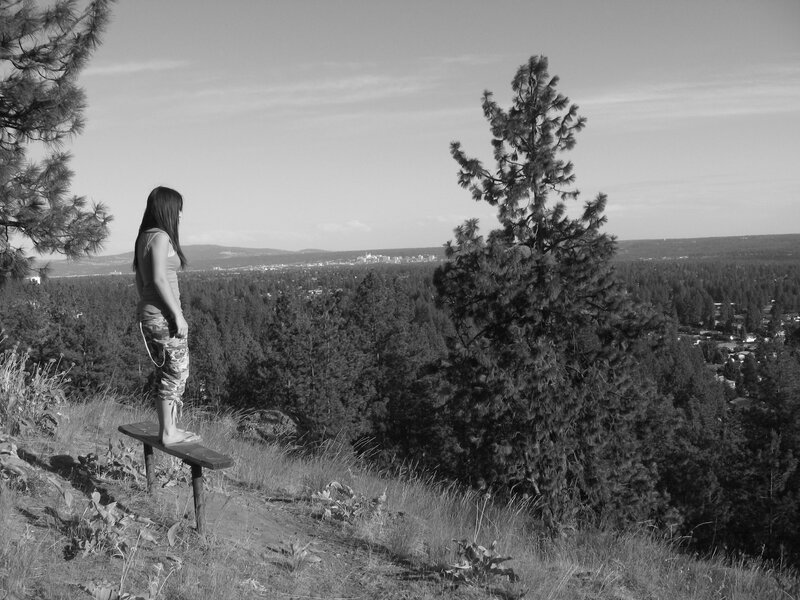 Woman on a bench overlooking a city