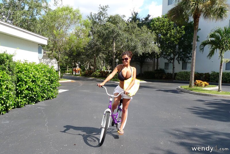 Woman on a bike with surfboard