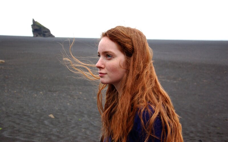 Woman on a black sand beach