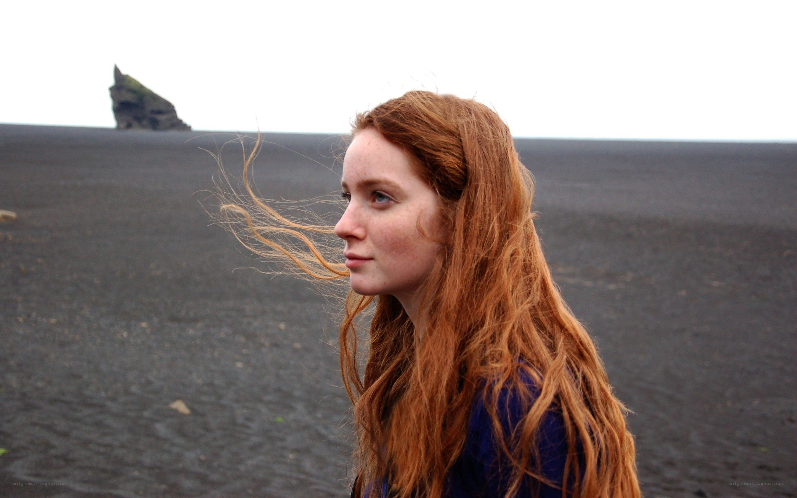 Woman on a black sand beach