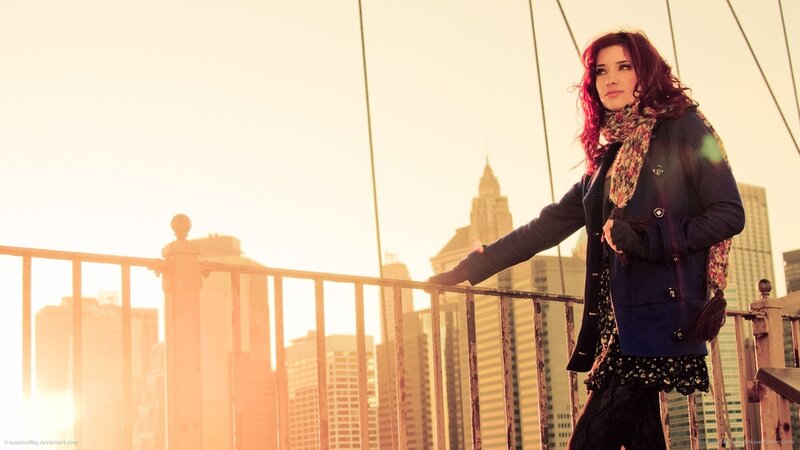 woman on a bridge at sunset