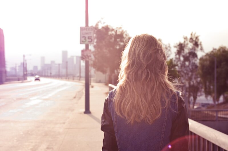 woman on a bridge at sunset