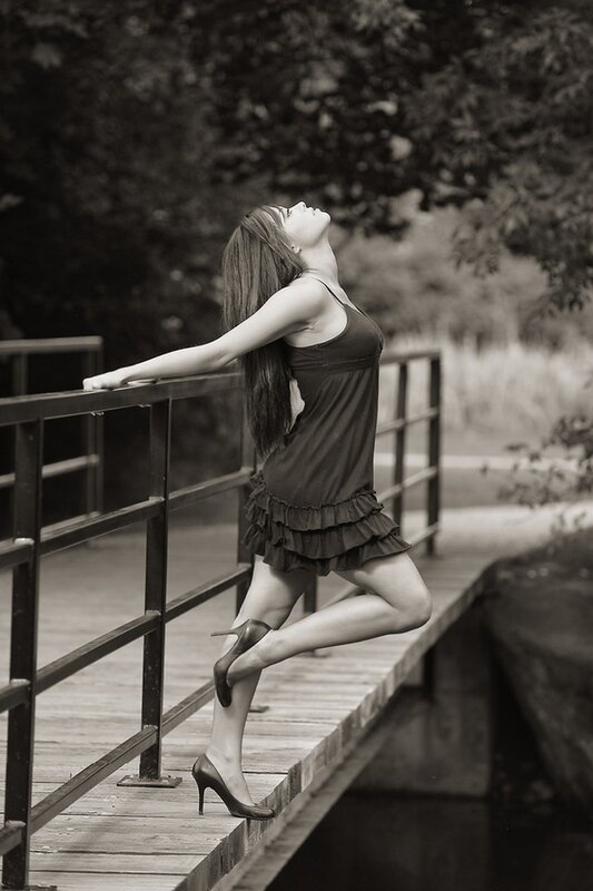 woman on a bridge in black and white