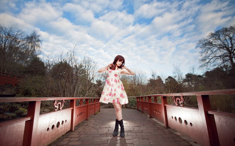 Woman on a bridge in floral dress