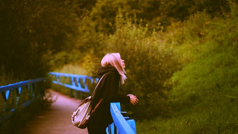 woman on a bridge in nature