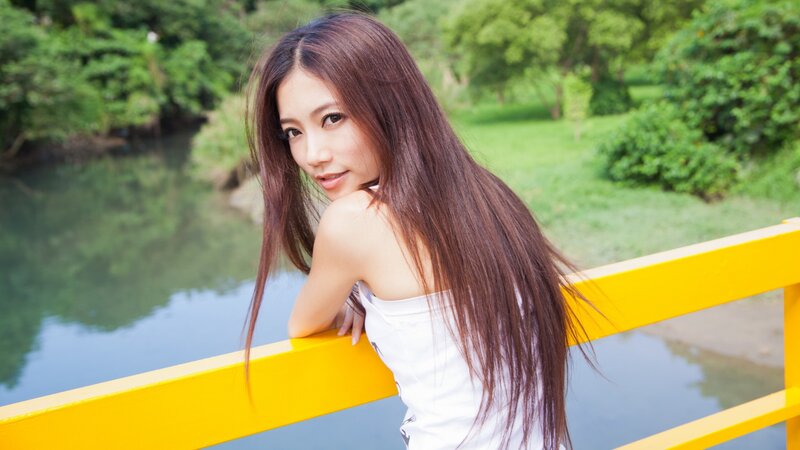 woman on a bridge in park