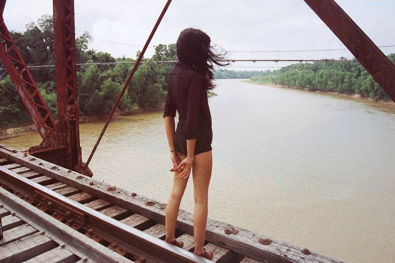 Woman on a bridge over a river