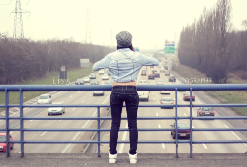 Woman on a bridge over highway