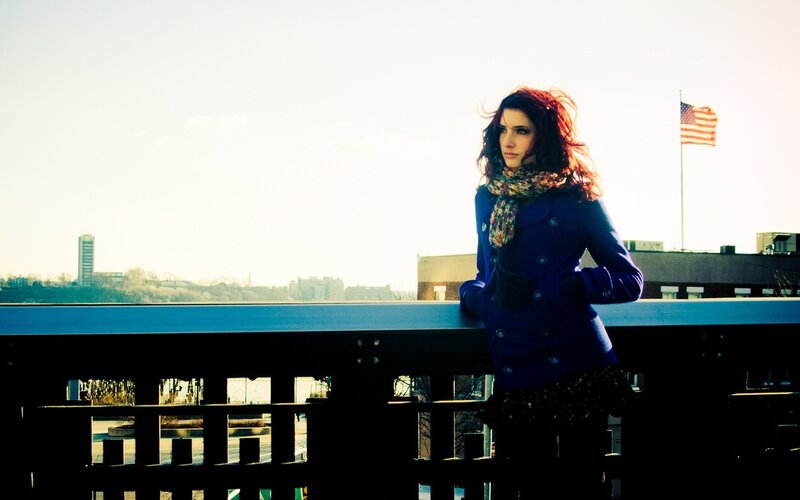 Woman on a bridge with American flag