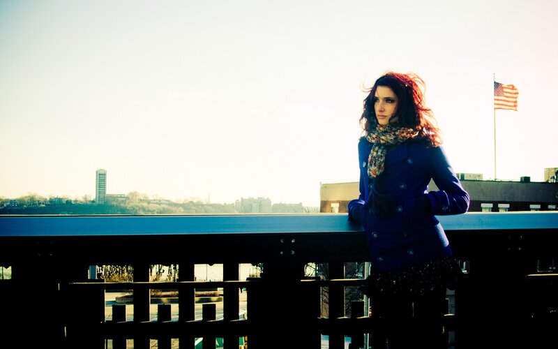 Woman on a bridge with city view