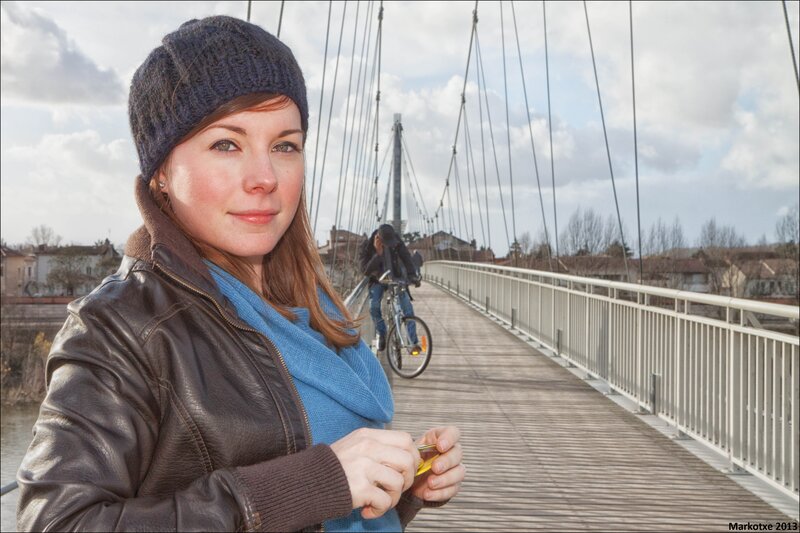 Woman on a bridge with cyclist