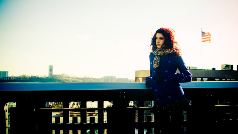 Woman on a bridge with flag