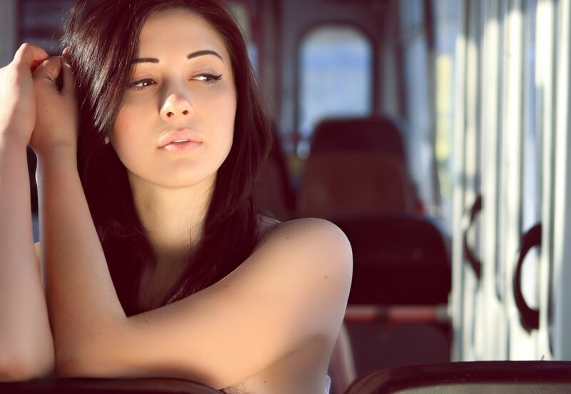 woman on a bus in sunlight