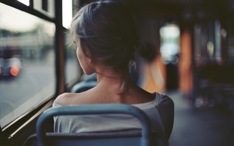 woman on a bus looking out the window