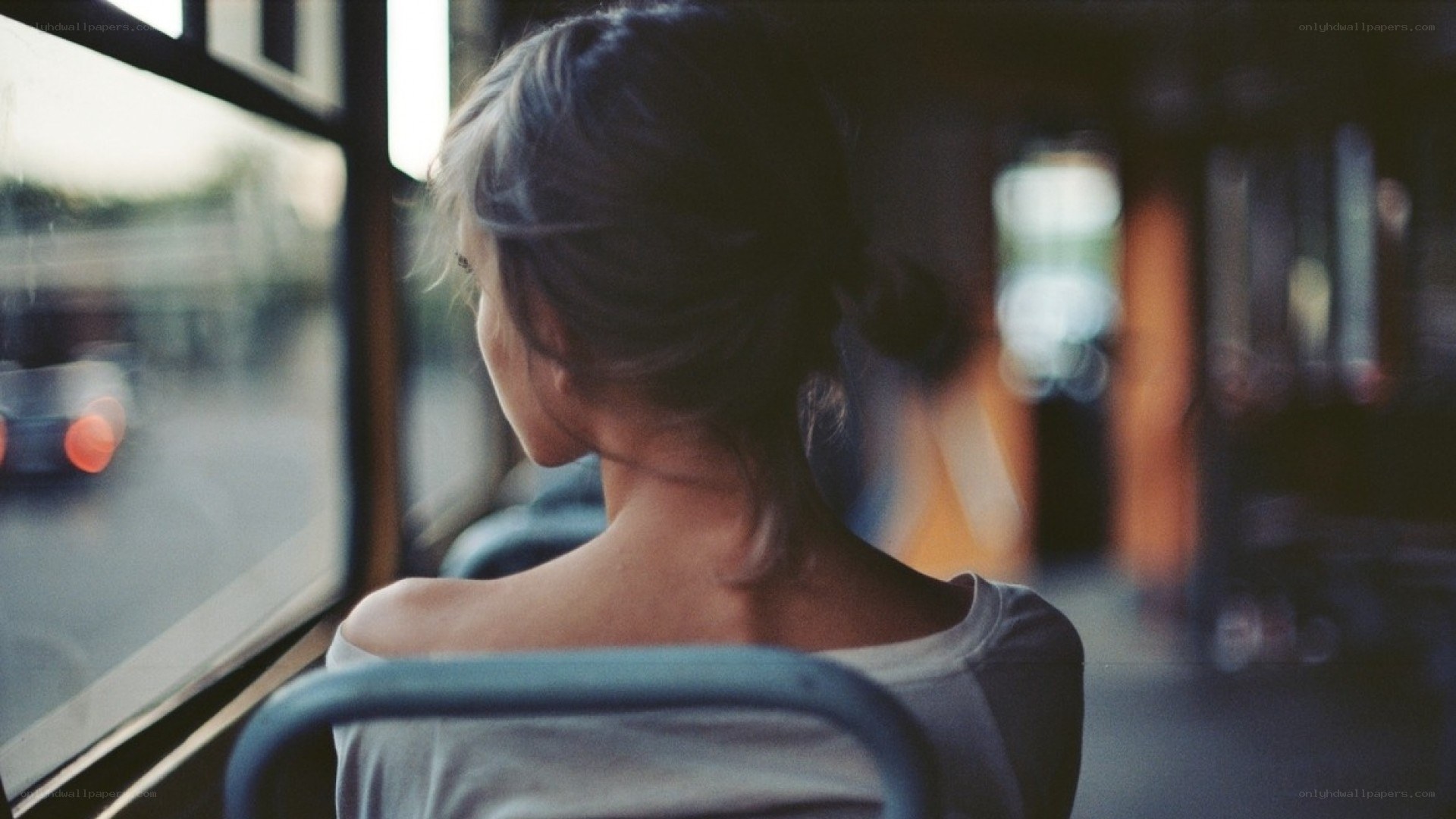 woman on a bus looking out window