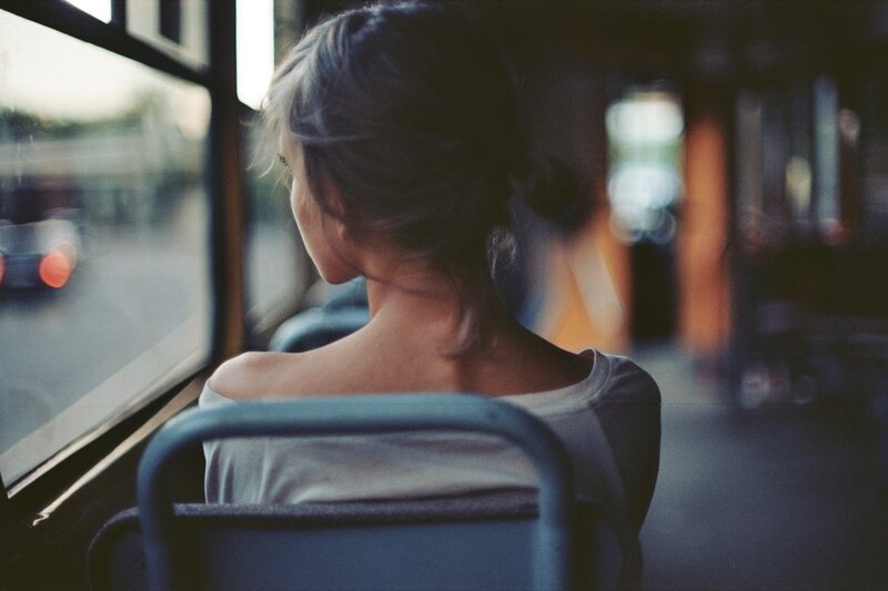 woman on a bus looking out window